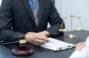 business attorney at desk with client