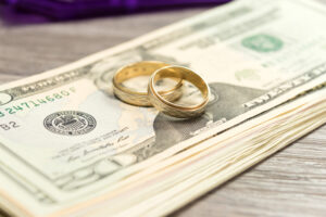 wedding bands on pile of cash representing a high asset divorce